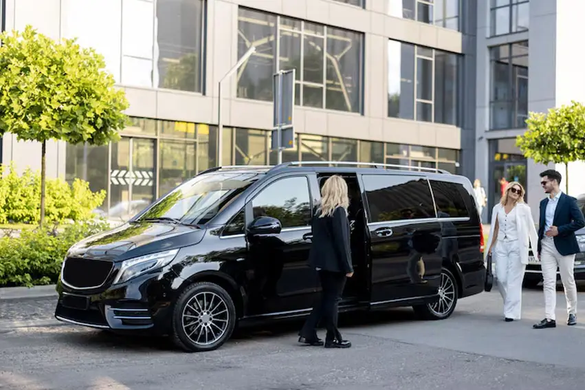 a woman walking into a black van