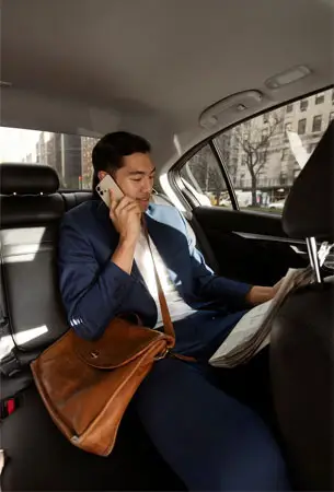 a man in a car talking on a cell phone
