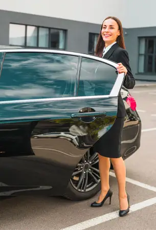 a woman leaning on a car
