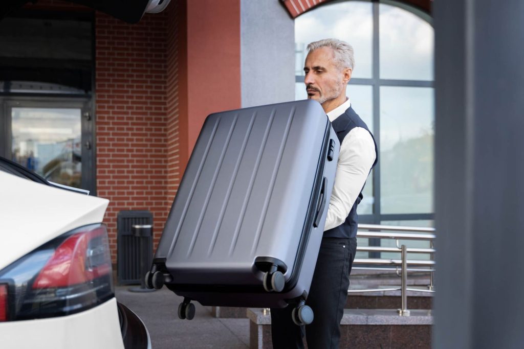 Private chauffeur assisting with luggage for luxury transportation