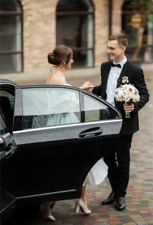 Luxury Wedding Transportation South Bay - Bride and Groom with Chauffeur Driven Sedan