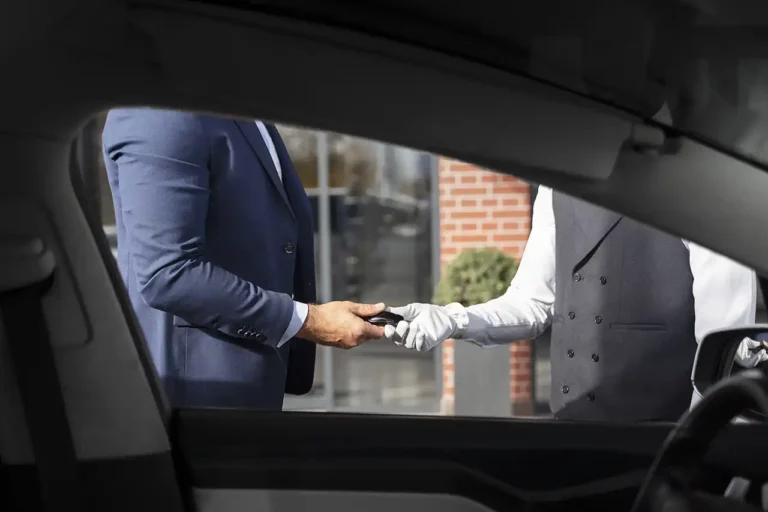Detail shot of a professional chauffeur opening a luxury vehicle door for Indian Wells limo service.